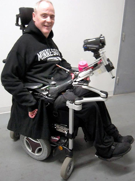 Happy man in wheelchair with mount and accessories.